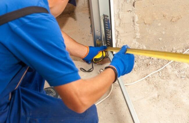 Garage Door Repair Guys carrying out precise garage door opener installation in Melbourne with accurate bracket measuring.